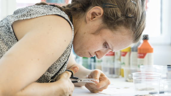 eine Bewohnerin der Wohngruppe von Viv Riva in Rapperswil-Jona beim exakten Arbeiten mit der Schere im Atelier
